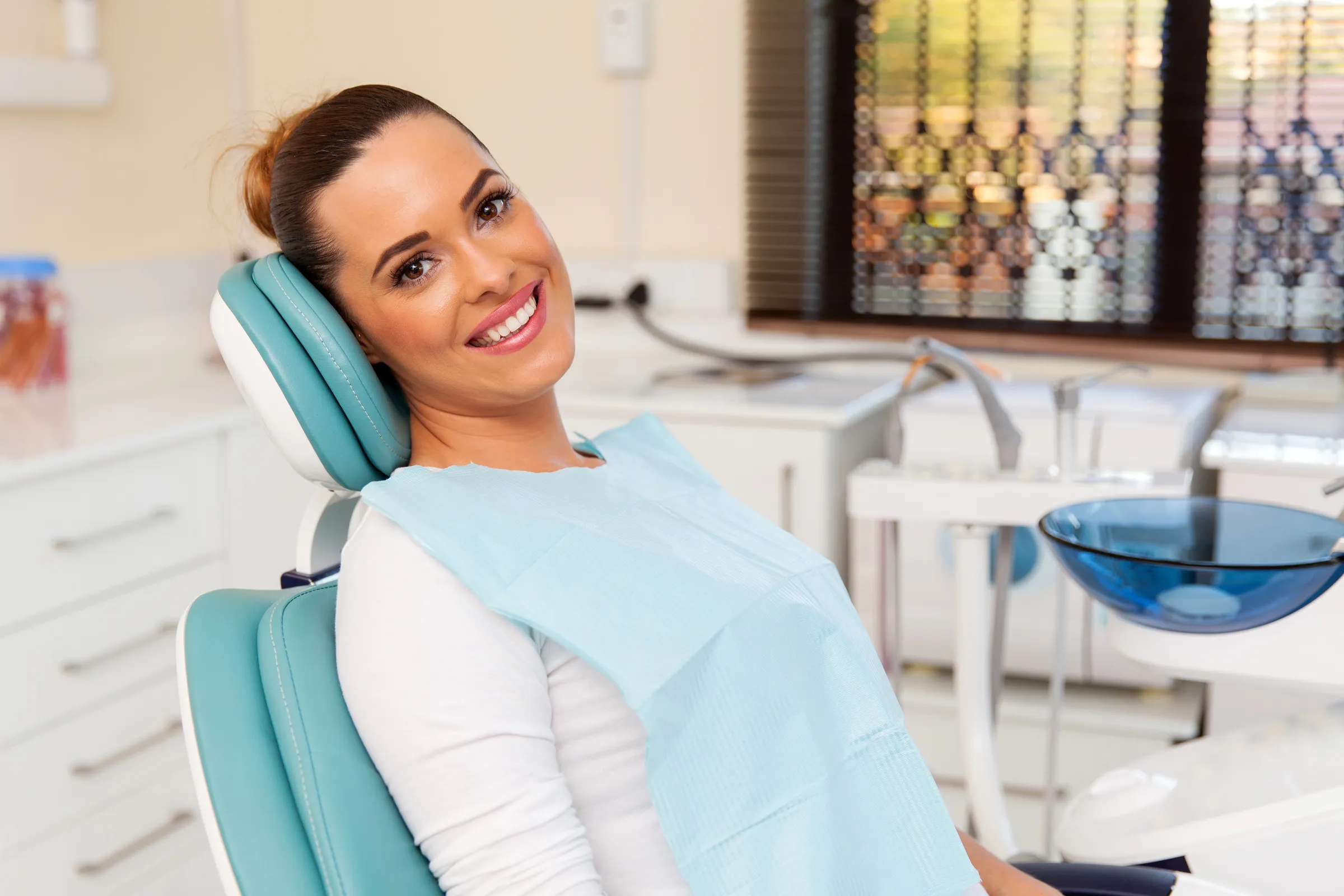 Dentist reviewing a patient's chart during an exam