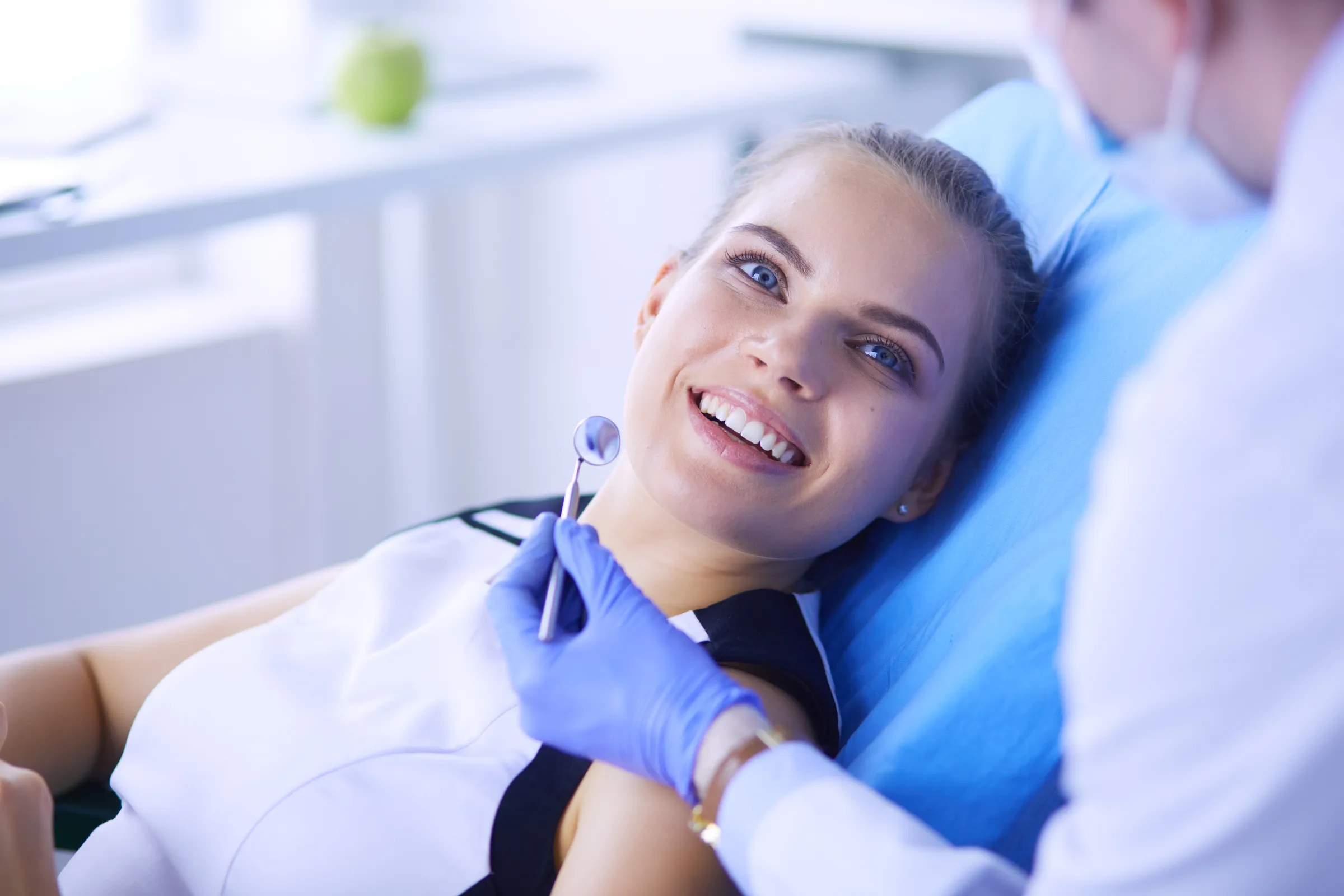 Patient and hygienist talking after a dental exam