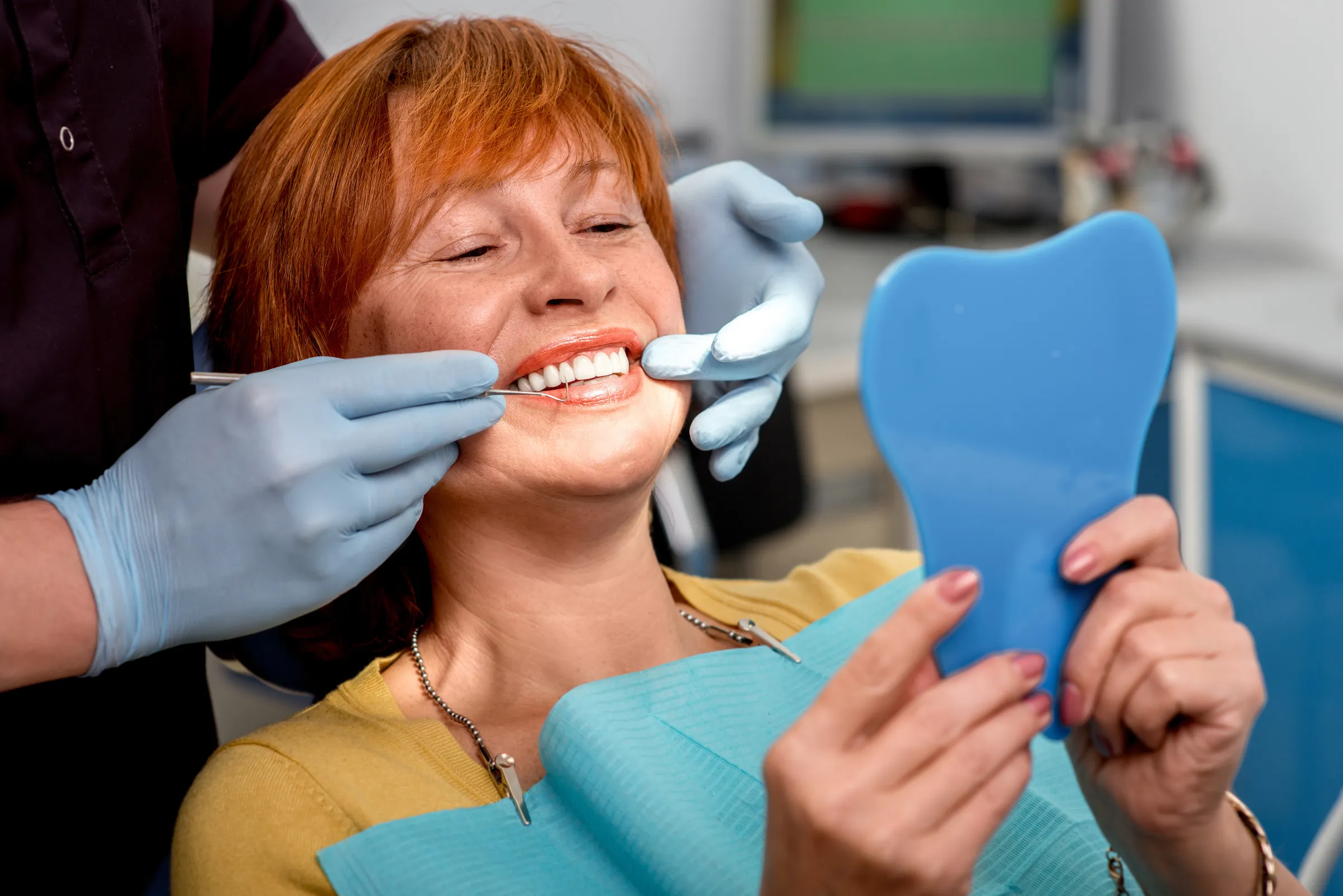 Dentist evaluating a patient's denture fit