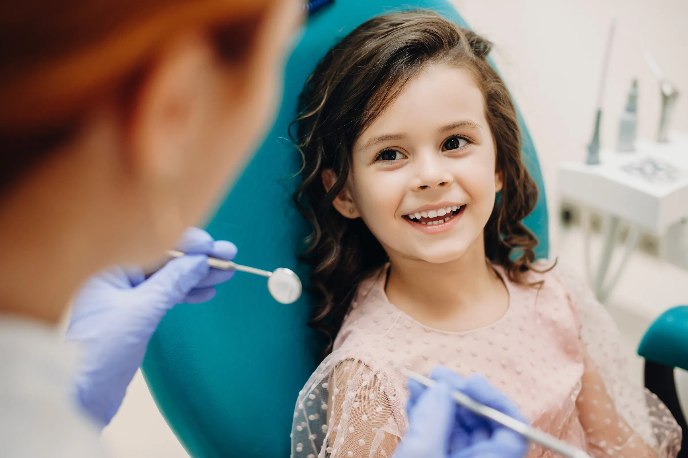 A young patient smiling during a pediatric dental exam