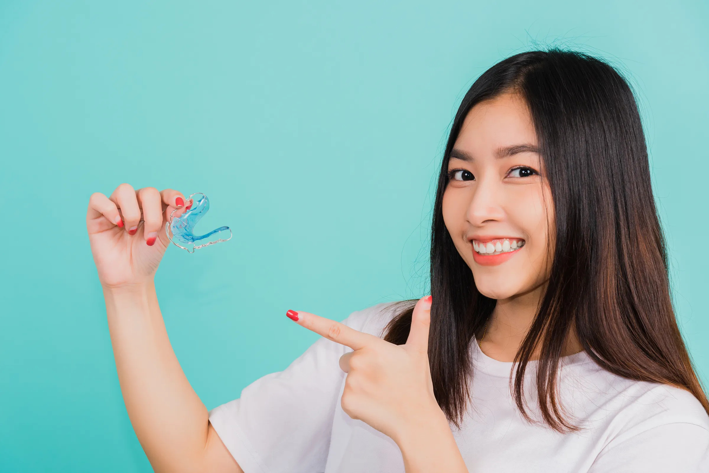 Dentist reviewing a retainer fit with a patient