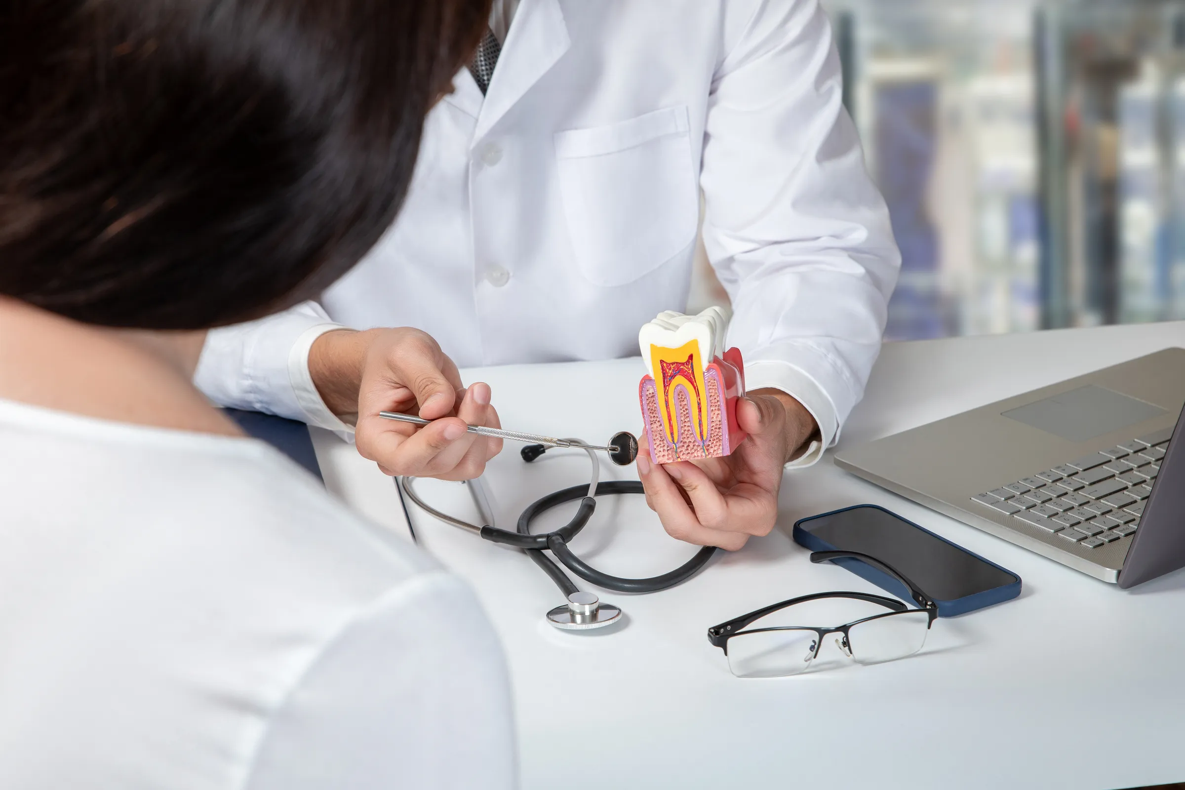 Dentist performing root canal treatment