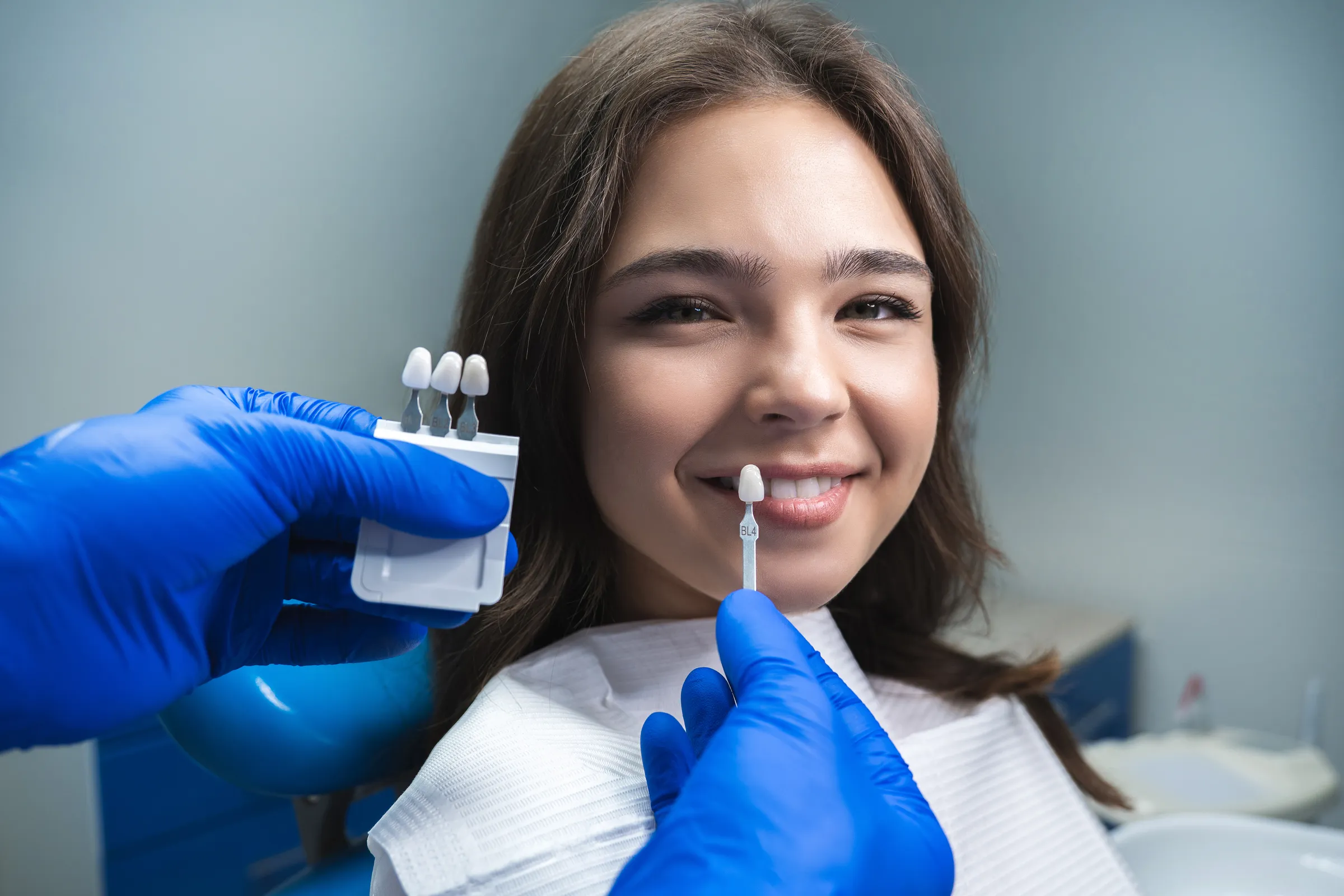 Patient smiling with new porcelain veneers