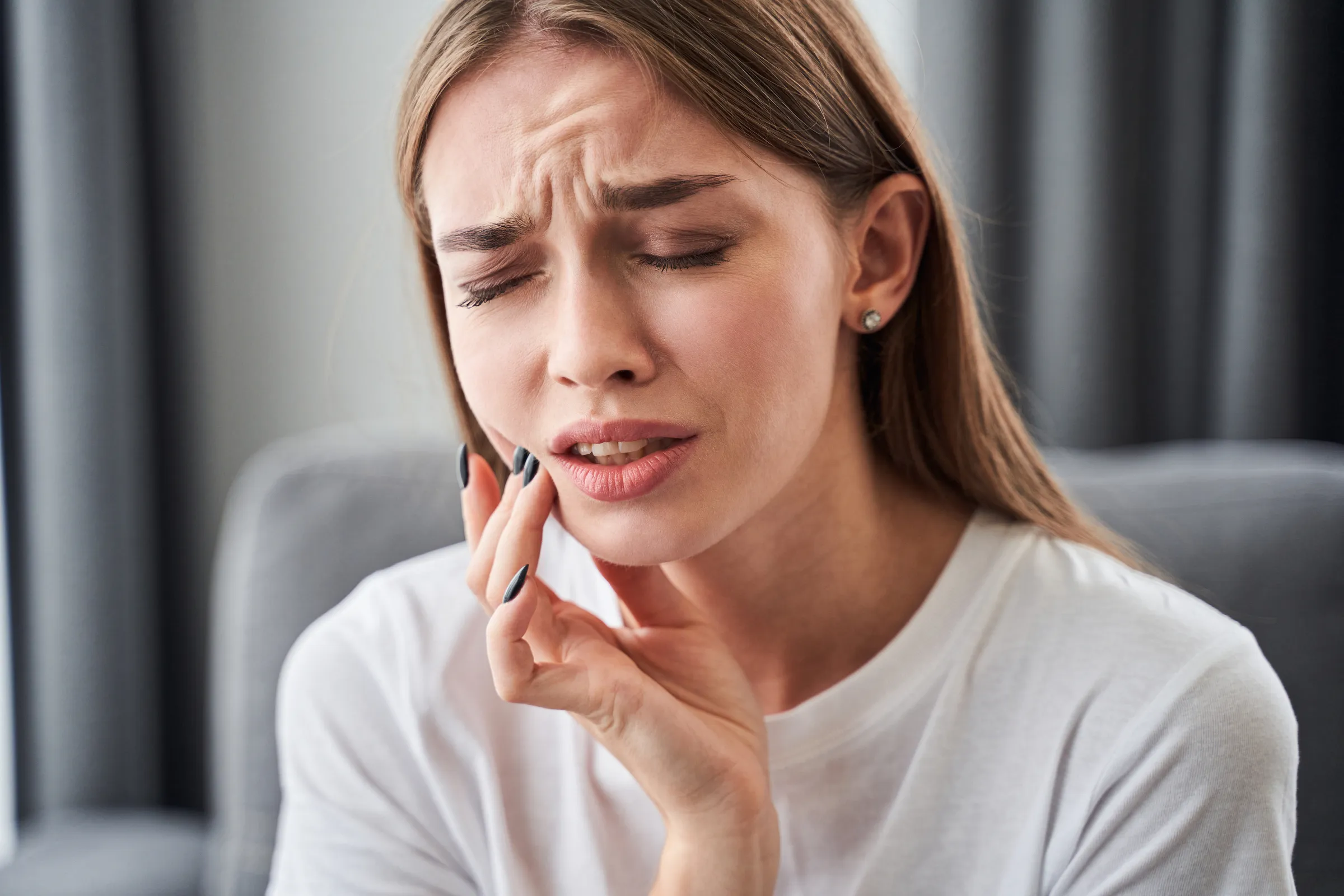 Patient resting during recovery after wisdom tooth extraction