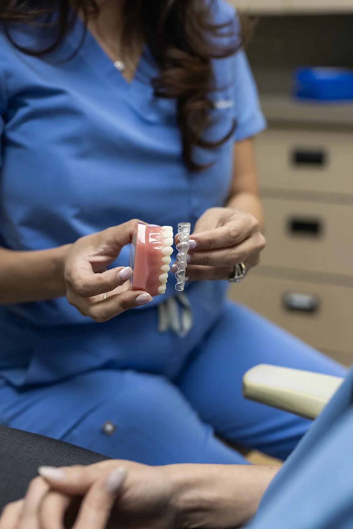 Dentist holding a clear aligner