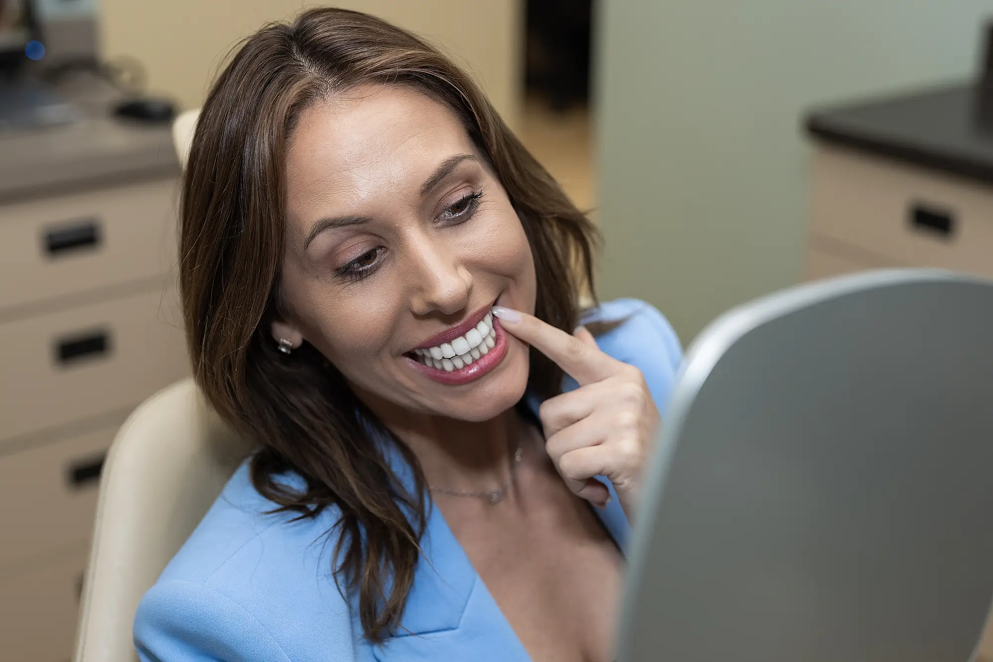 Women checking her teeth in the mirror