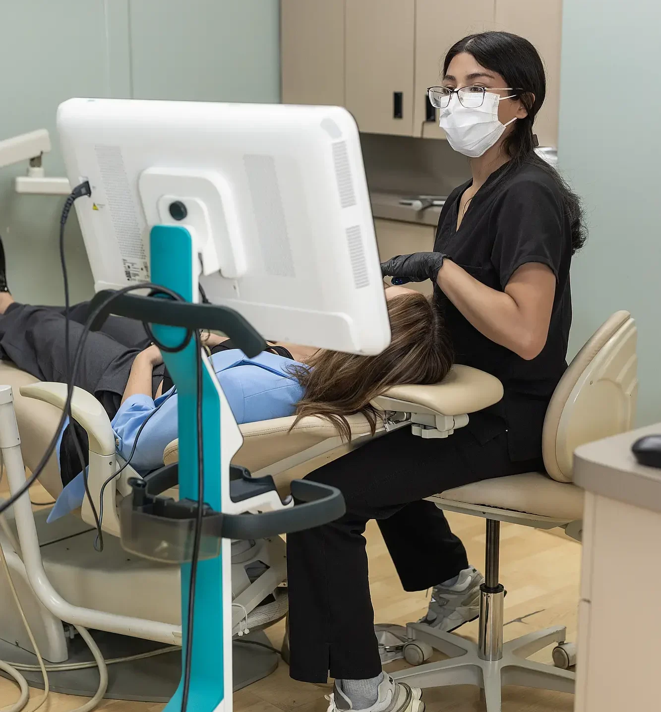 Dentist reviewing a patient's chart during an exam